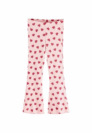Pink flared leggings with a ribbed texture, featuring a repeating pattern of small red hearts across the fabric.