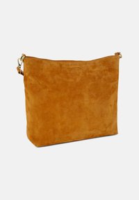 Tan suede handbag with a smooth texture, rectangular shape, zip closure at the top, and an adjustable strap with metal hardware.