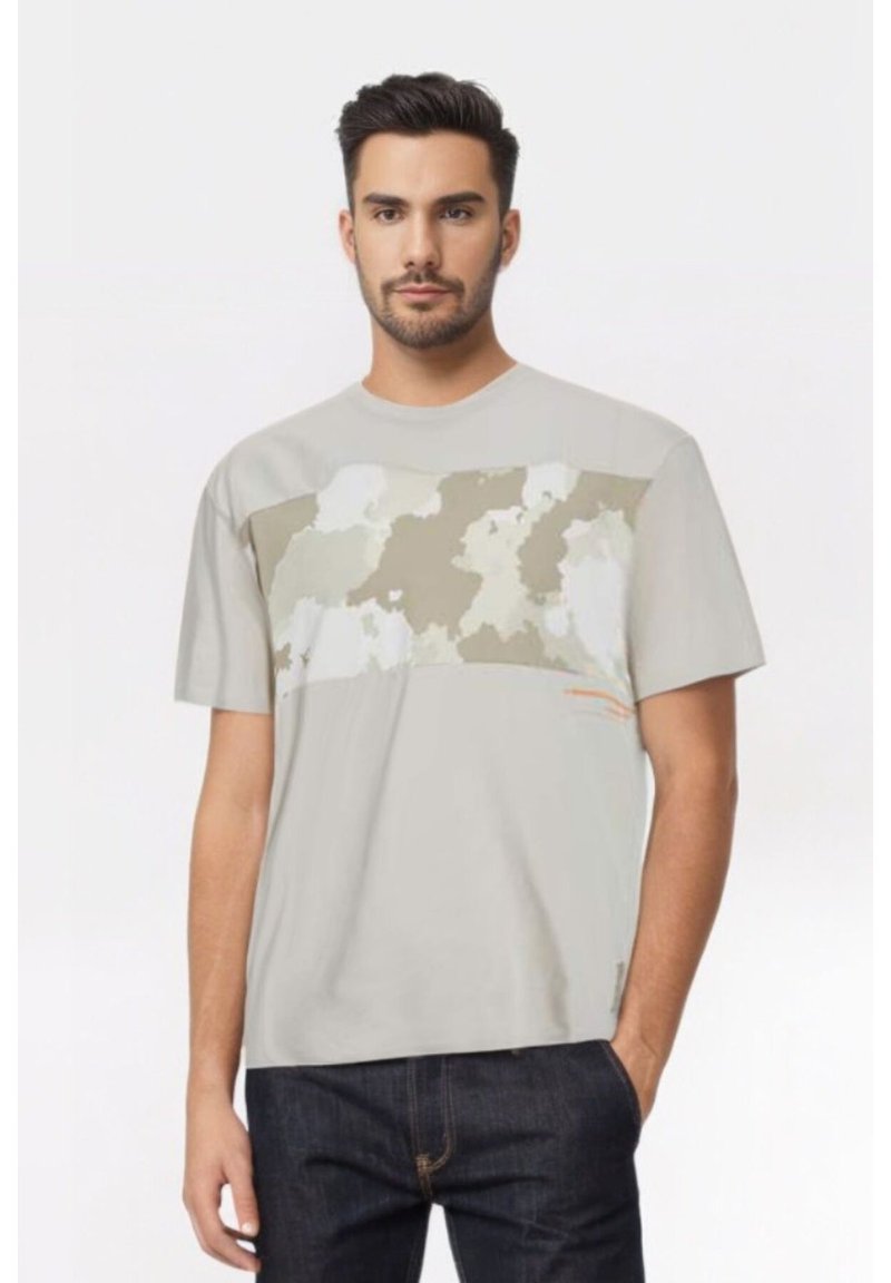 T-shirt grigio a maniche corte con una grande stampa camouflage astratta in toni smorzati sul petto e un piccolo dettaglio accentato in arancione.