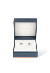 Silver cufflinks displayed in an open navy blue box with a textured white interior, featuring a minimalist design and no visible patterns.