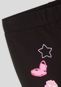Pantaloni di cotone neri con una texture morbida, caratterizzati da stampe rosa di una farfalla, una stella e un cuore. Vita semplice senza hardware.