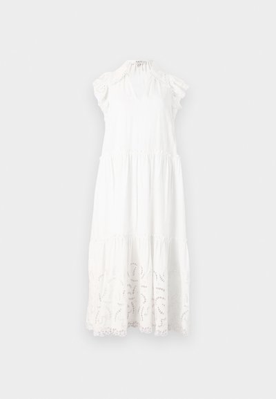 Λευκό βαμβακερό φόρεμα με σχεδίαση σε στρώσεις, ρυτίδες στους ώμους και περίπλοκες κοπές κοντά στο στρίφωμα.