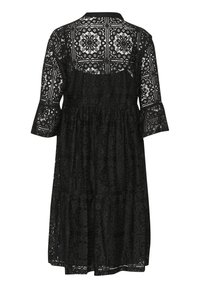 Black lace dress with a tiered design, featuring 3/4 bell sleeves, intricate patterns, and a round neckline. Textured fabric highlights details.