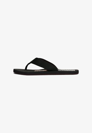 Infradito neri con una fascia testurizzata e una suola piatta in gomma. Presentano un design minimalista senza loghi o motivi visibili.