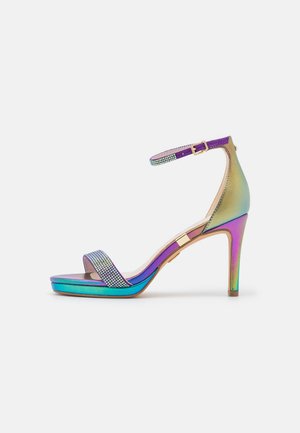 Strappy high-heeled sandal with iridescent finish, purple and turquoise hues, embellished with rhinestones on the toe strap, gold buckle.