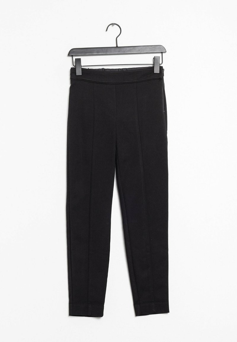 Leggings noirs en tissu extensible, dotés d'une taille haute, de zips sur les côtés et d'une texture lisse. Silhouette droite et ajustée.