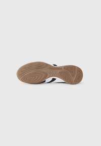 Black and white athletic shoe sole. Features textured, rubberized surface with a patterned grip. Molded "PREDATOR" branding present.