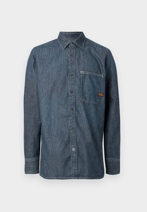 Denim overhemd met lange mouwen, knopenrij, puntige kraag en borstzak met een klein bruin merklabel.