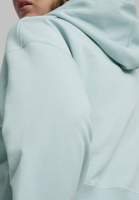Puma BETTER CLASSICS  - Jersey con capucha - turquoise surf