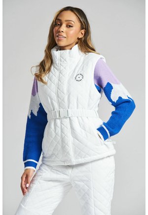 Quilted white vest with high collar, logo on chest, and color-blocked sleeves in blue, purple, and cream. Belted waist and side pockets.