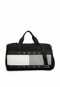 Sort og grå træningstaske med kontrasterende sektioner, iøjnefaldende "TOMMY JEANS" tekst, dobbelt bærehåndtag og en justerbar skulderrem.