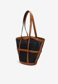 Bolso tote de tejido negro con acentos y asas de cuero marrón; presenta una forma estructurada y un diseño de malla abierta.