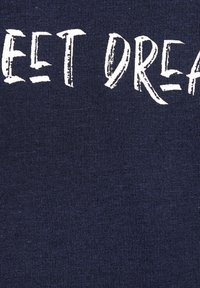 Navy blue cotton fabric featuring textured ribbing and white printed text that reads "SWEET DREAMS." No additional details or patterns present.