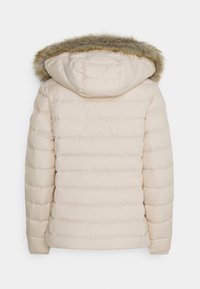 Beige gewatteerde jas met een met bont gevoerde capuchon, voorzien van horizontale stiksels en gebreide manchetten, ontworpen voor warmte en comfort.