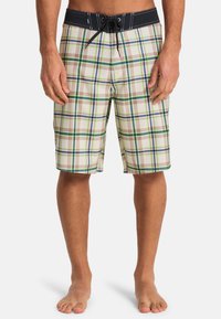Ανδρικό μαγιό σορτς σε μπεζ καρό μοτίβο με πράσινες και μπλε λεπτομέρειες. Διαθέτει μαύρο κορδόνι στη μέση και ελαφρύ υλικό.