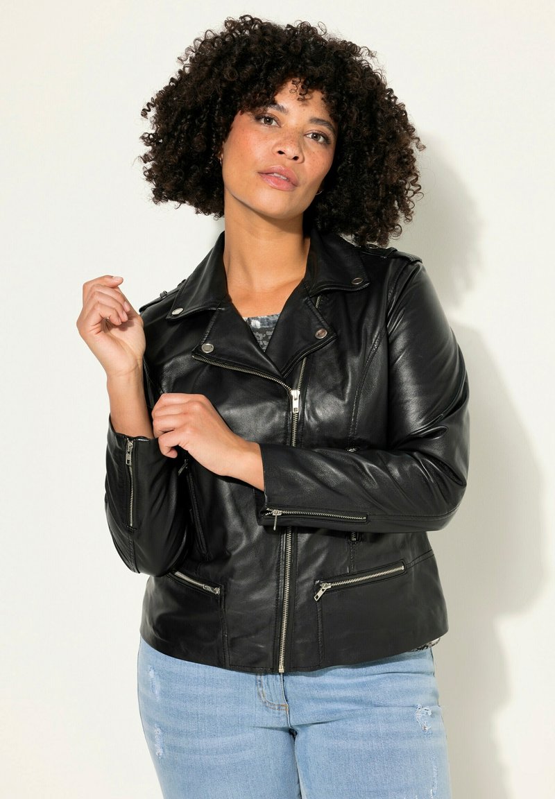 Veste de moto en cuir noir avec poches zippées et un col classique, présentant un design ajusté et une texture douce.