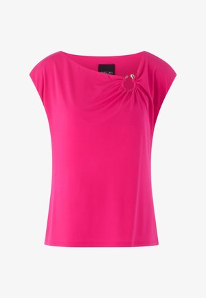 Bright pink short-sleeve blouse with asymmetric neckline gathered by a small gold-ring detail on the right side.