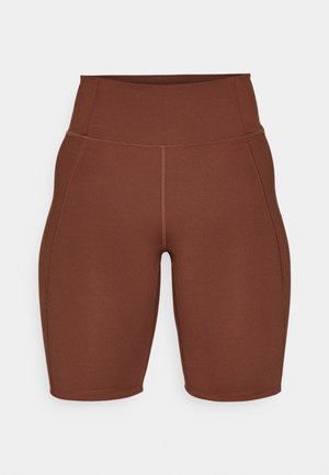 Pantalones cortos deportivos marrones con una cintura alta, hechos de una tela suave y elástica. Presenta costuras decorativas a lo largo de los lados.