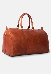 Brown leather duffel bag with rounded shape, two top handles, gold hardware accents, and visible stitching along the sides.