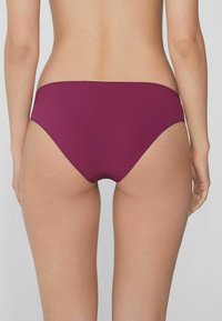 Burgunderfarbene Bikiniunterteile aus glattem Stoff. Sie verfügen über ein hochgeschnittenes Design mit minimaler Seitenbedeckung und sauberem Nähen an den Kanten.