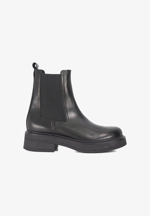 Black leather Chelsea boot with elastic side panels, round toe, chunky rubber sole, and a convenient pull tab at the back for easy wear.