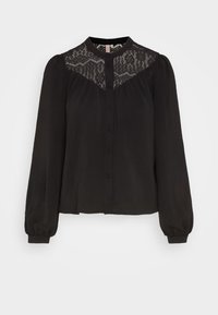 Blusa nera con maniche lunghe a palloncino, chiusura a bottoni e dettagli in pizzo sul petto. Presenta un collo alto e un tessuto morbido e testurizzato.