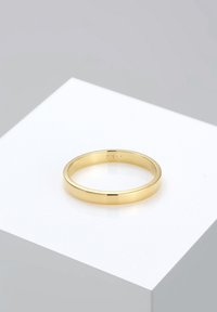 Gold ring with a smooth, polished surface; round shape; stamped with "375" inside. Set against a minimalistic white and gray background.