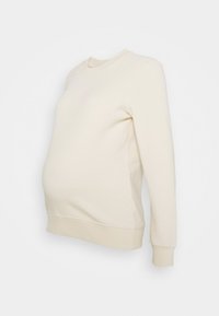 Sweatshirt de maternité en beige clair, avec un col rond et des manches longues. Tissu doux avec un ourlet ajusté, garantissant un confort durant le port.