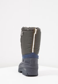 Botte imperméable grise avec une tige en tissu rembourré, semelle en caoutchouc bleue, et une bande d'accent blanche/marron à l'arrière. Semelle texturée pour une meilleure adhérence.