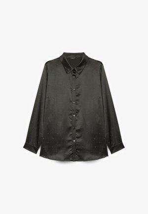 Musta satiinipaita, jossa on terävä kaulus, pitkät hihat ja hienovaraisia koristetäpliä. Edessä napitus ja sivuaukot.