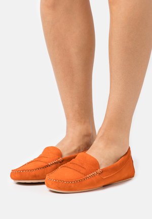 Orange suede loafers featuring a stitched design and a rounded toe. The texture is soft with a smooth sole.