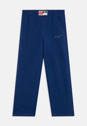 Navy blue cotton sweatpants with an elastic waistband, side pockets, and a subtle embroidered black Nike logo on the left thigh.
