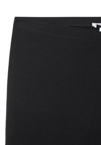 Leggings neri elasticizzati con una texture liscia, ampia fascia in vita e dettagli di cucitura curati lungo il bordo superiore.