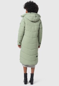Light green puffer coat with a hood, featuring a chevron pattern and side pockets. Made from a soft, smooth fabric. Knee-length design.