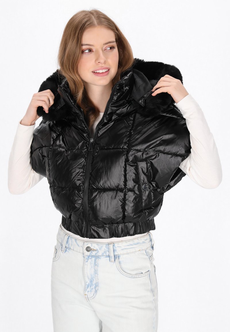 Czarna kurtka puchowa o połyskującej powierzchni, krótki krój, duży kaptur z futrzanym obszyciem i zapięciem na zamek. Lekka z pikowaną teksturą.