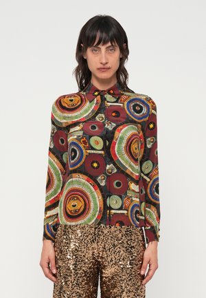 Long-sleeve button-up shirt featuring a multi-colored circular pattern on a black background, with a collar and buttoned cuffs.