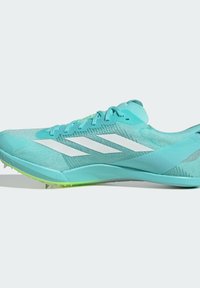 Aqua running shoe with a mesh upper, three white stripes, a textured design, and a green outsole with spikes for enhanced grip.