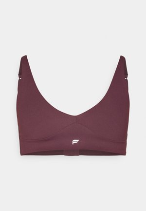 Burgundinės sportinės liemenėlės plačiomis petnešėlėmis, be siūlių dizainas ir logotipo akcentas. Pagaminta iš lygios tamprios medžiagos, užtikrinančios komfortą ir palaikymą.