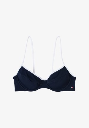 Top de biquíni azul-marinho com bainha branca, apresentando copas moldadas e alças finas. Inclui uma pequena etiqueta com logotipo na lateral.