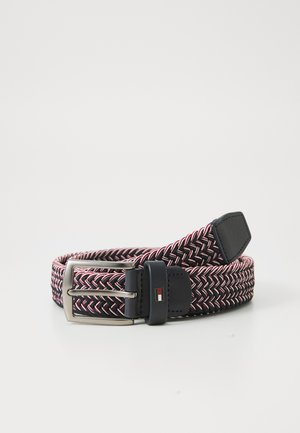 Elastic woven belt in navy, red, and white. Features a matte silver buckle and leather accents. Textured herringbone pattern throughout.