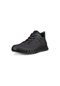 Black athletic shoe with a textured upper, green accents, and a flexible, ridged sole. Features lace-up closure and padded tongue.