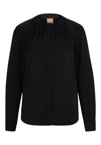 Svart blus med långa ärmar i ett slätt tyg, med en plisserad halsringning, knappframsida och manschettärmar. Enkel och strukturerad design.
