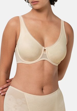 Beige blommig spets-bh med slät yta, bygelstöd och vågig kant. Har en lågskuren framsida och justerbara axelband.