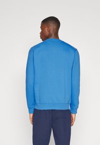 Tommy Jeans REGULAR C NECK - Sudadera - meridian blue