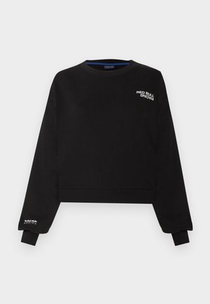 Must musta crewneck-pusa, millel on rindadel ja varrukatel tekst "Red Bull Racing", soonilised mansetid ja ääred, valgel taustal.