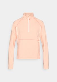 Μακρυμάνικο τοπ σε ανοιχτό ροδακινί χρώμα με φερμουάρ στο ένα τέταρτο, κατασκευασμένο από υφασμάτινο υλικό με υφή, με ψηλό γιακά και αντίθετες λευκές ραφές και διακοσμητικά στοιχεία.