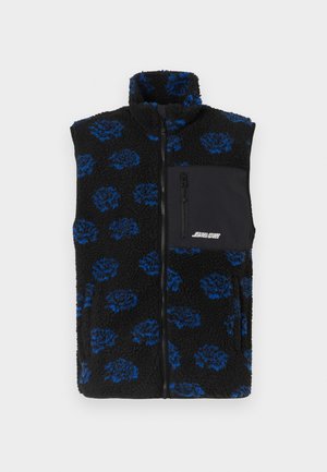 Fekete, bolyhos fleece mellény kék virágmintával, magas gallérral és fekete cipzáras zsebbel a mellkason. Teljes elülső cipzáras záródás.