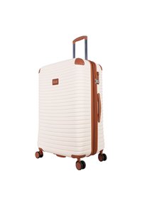 Hard-shell suitcase in cream with horizontal ridges, brown accents, spinner wheels, and a retractable handle. Features a lock mechanism.