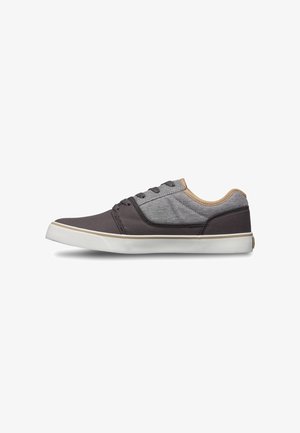 Low-top sneaker with gray fabric upper, dark gray accents, beige lining, white rubber sole, and lace-up closure on white background.