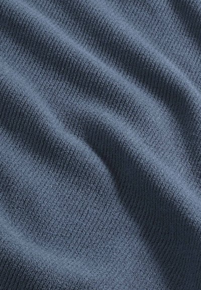 Tessuto a coste di un blu navy con una consistenza morbida, caratterizzato da profonde scanalature e un leggero lucido, creando un aspetto fluido e ondulato.